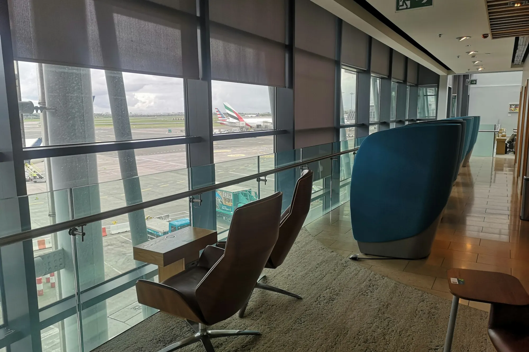 A quiet airport lounge with armchairs and a view of the apron