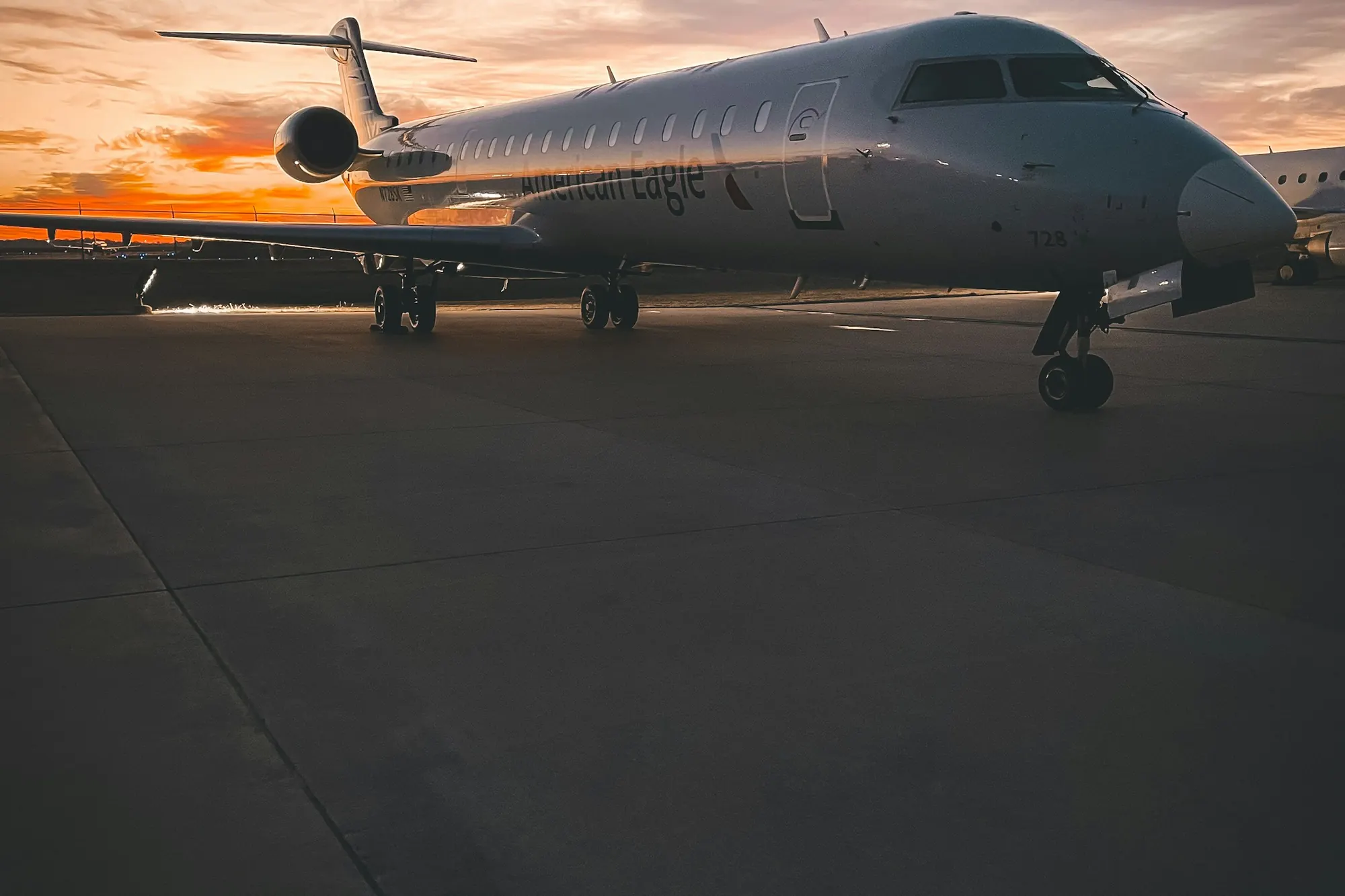 A business jet on the ramp at dusk, seen head-on
