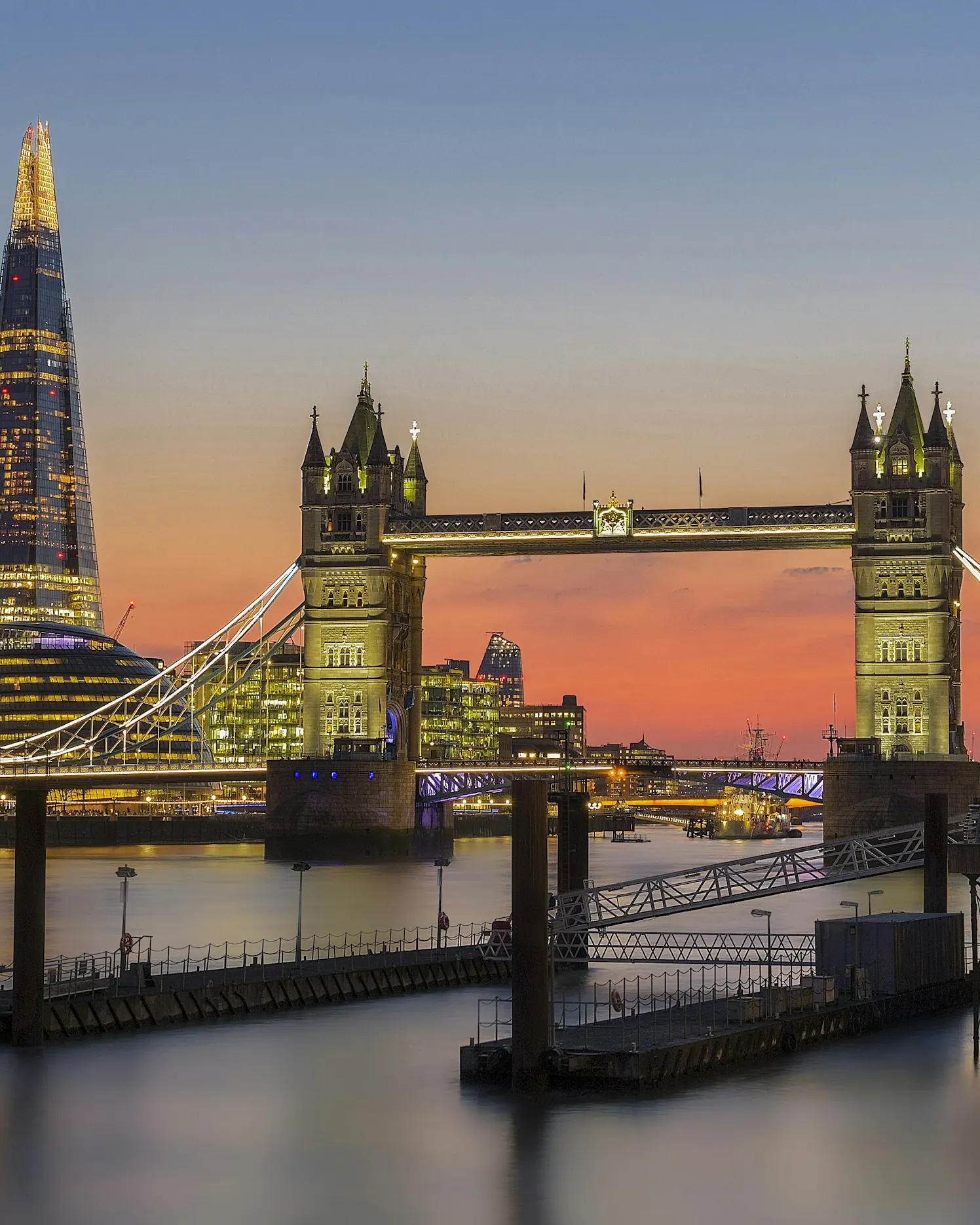 Tower Bridge lit at dusk with the Shard behind it